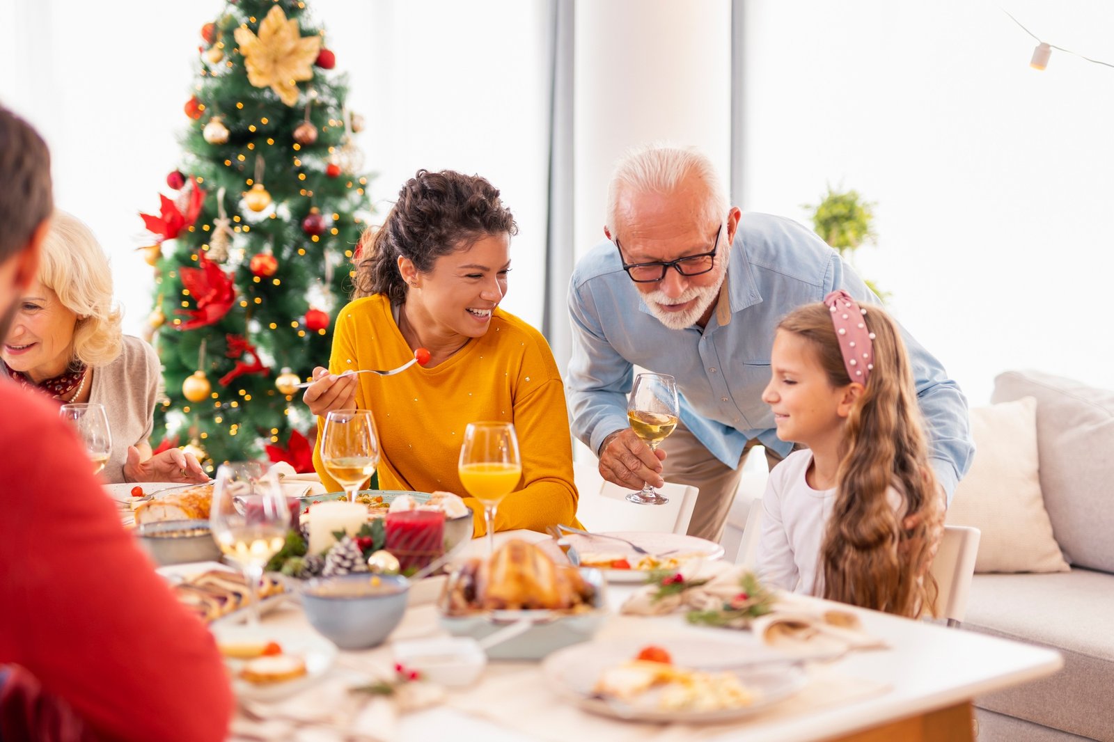 Family gathered around the table having Christmas dinner at home